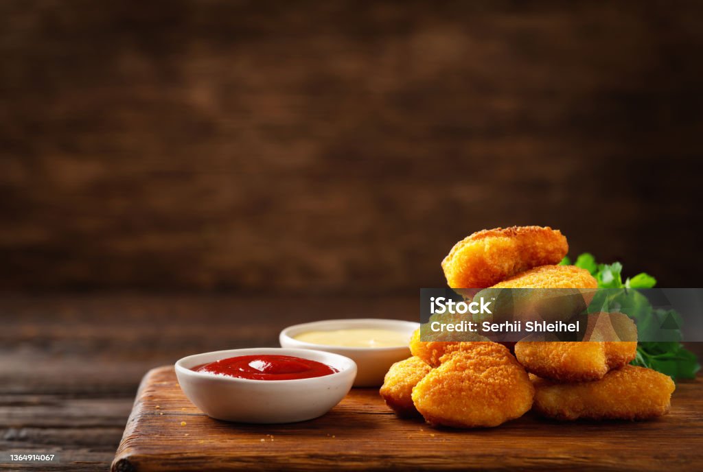 Homemade chicken nuggets and sauces with copy space